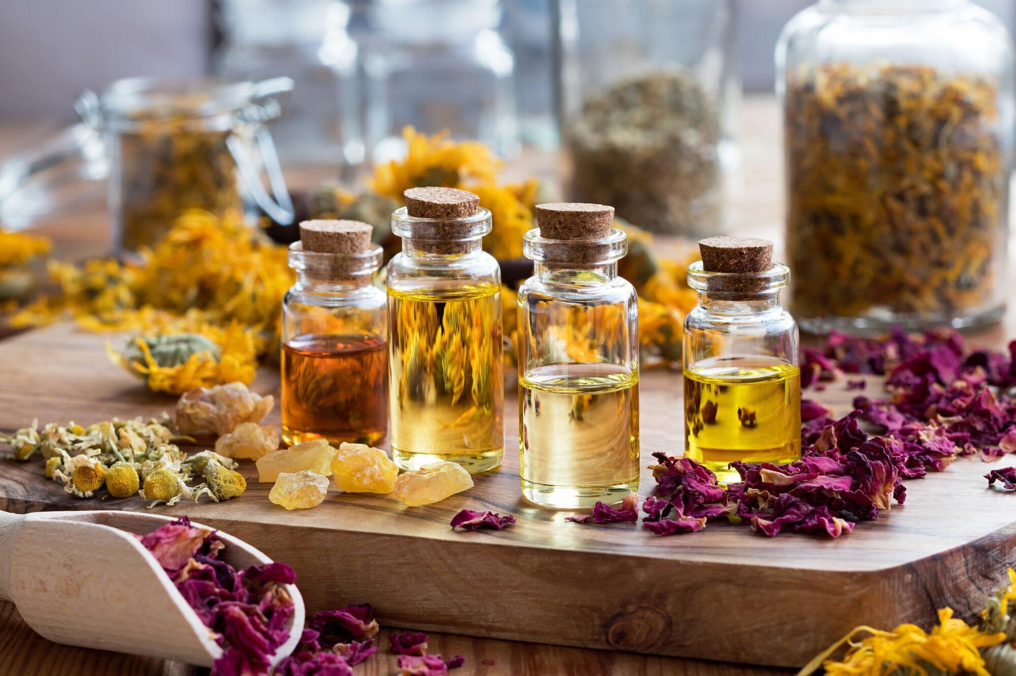 Bottles of essential oil with herbs and frankincense resin